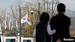 Bendera nasional Korea Selatan dikibarkan setengah tiang di kompleks pemerintah untuk menghormati para korban perayaan Halloween di distrik Itaewon yang populer di Seoul, 30 Oktober 2022. (Yonhap/Reuters)