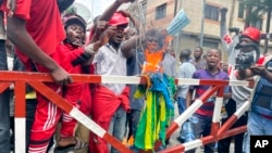 FILE - Residents burn a Rwandan flag during protest in Goma, Democratic Republic of the Congo, Oct. 30, 2022. M23 rebels have seized control of two major towns in eastern Congo and doubled the territory they hold after fierce fighting with the Congolese military.