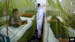 FILE - Pakistani patients suffering from dengue fever, a mosquito-borne disease, are treated in an isolation ward, at a hospital in Lahore, Pakistan, Sept. 23, 2022. 