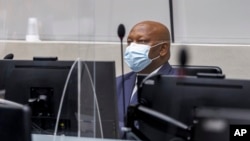 FILE - Kenyan lawyer Paul Gicheru listens to charges against him in the case against President William Ruto at the opening hearing at the International Criminal Court in The Hague, Netherlands, Feb. 15, 2022. 