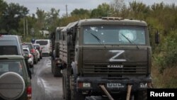 FILE - Destroyed Russian military vehicles with the "Z" symbol are seen, as Russia's attack on Ukraine continues, in Kharkiv region, Ukraine, Sept. 13, 2022.