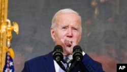 FILE - President Joe Biden coughs as he speaks at the White House in Washington, July 28, 2022. Biden tested positive for COVID-19 again July 30, slightly more than three days after he was cleared to exit coronavirus isolation.