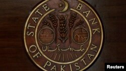 FILE - The logo of the State Bank of Pakistan (SBP) is pictured on a reception desk at the head office in Karachi, Pakistan, July 16, 2019.