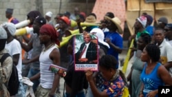 Supporters of the Fanmi Lavallas political party mark the birthday of its founder and leader, former President Jean-Bertrand Aristide, in Port-au-Prince, Haiti, July 15, 2022. Aristide was toppled twice from power, his second term ending in 2004 amid a violent rebellion.
