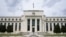 FILE - An American flag flies over the Federal Reserve building in Washington, May 4, 2021. A report issued July 26, 2022, by Senate Republicans alleges that China is trying to infiltrate the Federal Reserve. 