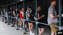 People wait in line to receive the monkeypox vaccine before the opening of a new mass vaccination site at the Bushwick Education Campus in Brooklyn, New York, July 17, 2022. (Photo by Kena Betancur / AFP)