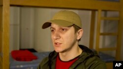 Dmitriy Zadoyanov, an evacuee from Mariupol, speaks during an interview in Tbilisi, Georgia, April 15, 2022. When he chose to be evacuated, the only options were buses to Russia.