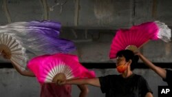 Beijing residents find refuge under a bridge and try to cool off on July 21, 2022, as China faces extreme heat as well as a rare tornado the day before. 