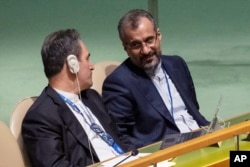 Iran's delegates look at each other while U.S. Secretary of State Antony Blinken addresses the 2022 Nuclear Non-Proliferation Treaty review conference, in the United Nations General Assembly, Aug. 1, 2022.