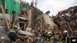 Rescuers remove debris following a Russian missile attack in Chuhuiv, Kharkiv region, Ukraine, July 25, 2022.
