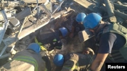 Rescuers release a man from the ruins of a residential building destroyed by a Russian military strike in the town of Toretsk, Donetsk region, Ukraine July 18, 2022, in this photo released by the State Emergency Service of Ukraine.
