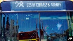 A bus driver wears a mask while picking up passengers along Hill Street, July 13, 2022, in Los Angeles. Los Angeles County might be imposing a mandate later this month if COVID-19 numbers continue to rise.