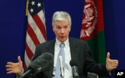 FILE - Then- U.S. ambassador to Afghanistan Ryan Crocker gestures during a press conference at the U.S. Embassy in Kabul, Dec. 10, 2011
