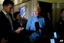 FILE - President Joe Biden talks to reporters aboard Air Force One during a refueling stop at Ramstein Air Base in Germany, Oct. 18, 2023, as he travels back from Israel to Washington.