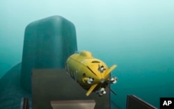 In this video grab provided by RU-RTR Russian television via AP television on Thursday, March 1, 2018, a computer simulation shows a Russian nuclear-powered underwater drone being released by a submarine.