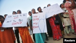Demonstrators hold placards as they take part in a protest rally in solidarity with a rape victim from New Delhi in Mumbai, December 27, 2012.
