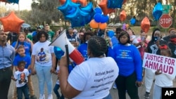 FILE - Thea Brooks, an aunt of Ahmaud Arbery, addresses supporters at the intersection where the Black man was fatally shot two years ago, in Brunswick, Ga., Feb. 23, 2022. Three white men who chased and killed Arbery have been convicted of murder and federal hate crimes.