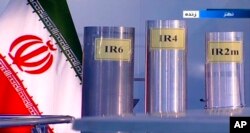 FILE - Three versions of domestically-built centrifuges are shown in a live TV program from Natanz, an Iranian uranium enrichment plant, in Iran, in this June 6, 2018, frame grab from the Islamic Republic Iran Broadcasting state-run TV.