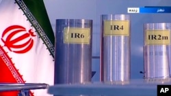 FILE - Three versions of domestically built centrifuges are shown in a live TV program from Natanz, an Iranian uranium enrichment plant, in Iran, in this June 6, 2018, frame grab from the Islamic Republic Iran Broadcasting state-run TV. 