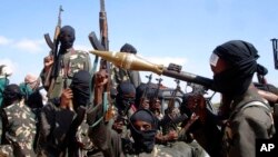 FILE - Armed al-Shabab fighters prepare to travel into the city, just outside the capital of Mogadishu, Somalia, Dec. 8, 2008. Somalia is pushing to have an arms embargo lifted in order to better fight the extremists. The U.N. Security Council is set to vote in November 2022.