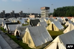 A general view shows tents installed for displaced people at a makeshift camp after they fled from their flood hit homes following heavy monsoon rains in Charsadda district of Khyber Pakhtunkhwa, Aug. 29, 2022.(Photo by Abdul MAJEED / AFP)