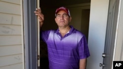 Rolando José Cisneros Borroto in his apartment, Friday, Aug. 26, 2022, in Algona, Iowa. (AP Photo/Charlie Neibergall)