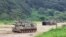 South Korean army K-9 self-propelled howitzers take positions in Paju, near the border with North Korea, South Korea, Aug. 22, 2022. The US and South Korea began their biggest combined military training in years Monday.