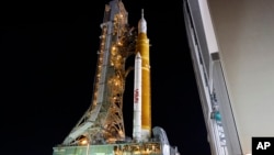 The NASA Artemis rocket with the Orion spacecraft aboard leaves the Vehicle Assembly Building moving slowly to pad 39B at the Kennedy Space Center in Cape Canaveral, Fla., Tuesday, Aug. 16, 2022. (AP Photo/Terry Renna)