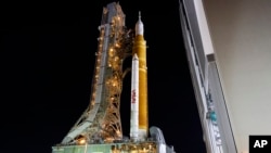 The NASA Artemis rocket with the Orion spacecraft aboard leaves the Vehicle Assembly Building moving slowly to pad 39B at the Kennedy Space Center in Cape Canaveral, Fla., Tuesday, Aug. 16, 2022. (AP Photo/Terry Renna)