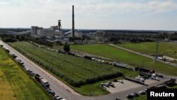 Cars and trucks queue for more than a kilometer to pick up coal in front of the Bogdanka mine in Bogdanka, Poland, Aug. 26, 2022.