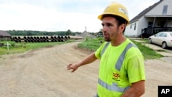 Taylor Purdy, a pipe layer with Complete General Construction, answers questions about his experience working around the new Intel semiconductor manufacturing plant construction site on Friday, Aug. 5, 2022. (AP Photo/Paul Vernon)