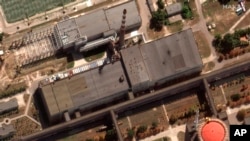 This satellite image provided by Maxar Technologies shows recent damage to the roof of a building adjacent to several of the nuclear reactors at the Zaporizhzhia nuclear plant, Aug. 29, 2022. (Satellite image ©2022 Maxar Technologies via AP)
