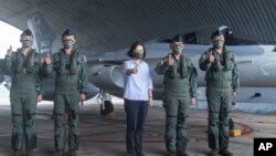 In this photo released by the Taiwan Ministry of National Defense, Taiwan's President Tsai Ing-wen is briefed during a visit to a naval station on Penghu, an archipelago of several dozen islands off Taiwan's western coast, Aug. 30, 2022.