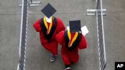 FILE - New graduates walk into the High Point Solutions Stadium before the start of the Rutgers University graduation ceremony, in Piscataway Township, New Jersey, May 13, 2018.
