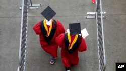 FILE - New graduates walk into the High Point Solutions Stadium before the start of the Rutgers University graduation ceremony, in Piscataway Township, New Jersey, May 13, 2018.