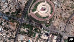 This satellite image provided by Maxar Technologies shows small fires near the tomb of unknown soldier and Iraqi parliament building in Baghdad, taken Aug. 30, after Muqtada al-Sadr called on his supporters to withdraw from the capital's government quarte
