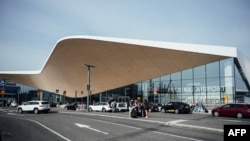 FILE - Cars and travelers are seen at the Helsinki airport in Vantaa, Finland, Aug. 19, 2022. Officials from Turkey, Finland and Sweden met in Vantaa on Aug. 26, 2022.