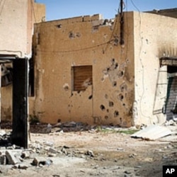 Heavy gunfire pockmarks houses in the Bira neighborhood in Misrata, a rebel bastion 120 kms (75 miles) east of Tripoli, on April 15, 2011