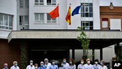 Health services staff members stand outside at Navarra Hospital in a two minute silence in tribute for members of staff who died of coronovirus, in Pamplona, northern Spain, May 14, 2020.