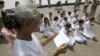 FILE - Rape victims who never received hearings for allegations pray in front of Royal Palace, Phnom Penh, Cambodia.