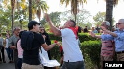Pro and anti-government supporters scuffle during a funeral for Nicaraguan poet and priest Ernesto Cardenal at the Metropolitan Cathedral in Managua, Nicaragua, March 3, 2020. Journalists covering the funeral were also attacked and beaten.