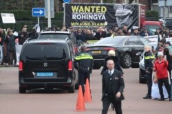 FILE -Myanmar's leader Aung San Suu Kyi leaves in a car after attending a hearing in a case filed by Gambia accusing Myanmar of genocide against the minority Muslim Rohingya population, at the International Court of Justice at The Hague, Netherlands.