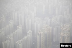 Apartment complexes are seen shrouded by fine dust during a polluted day in Seoul, South Korea, March 6, 2019.