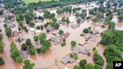 Flooded homes are seen along the Arkansas River in Sand Spring, Okla., in this May 28, 2019, aerial photo.