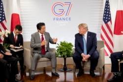 U.S President Donald Trump, right, and Japanese Prime Minister Shinzo Abe attend a bilateral meeting at the G-7 summit in Biarritz, France, Aug. 25, 2019.