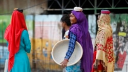 Laborers work at a road construction site in Prayagraj, India, Nov. 13, 2021.