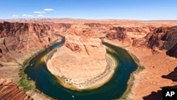 FILE - The Colorado River flows at Horseshoe Bend in the Glen Canyon National Recreation Area, in Page, Arizona, June 8, 2022.