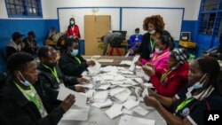 Maafisa wa uchaguzi wakihesabu kura katika kituo cha kupiga kura cha Shule ya Msingi ya Kilimera, Nairobi, Kenya, Aug. 9, 2022. 