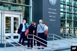 24일 미 법무부의 브라이언 네터 변호인(맨 왼쪽)이 아이다호주 보이시 연방법원 청사에서 변론 후 소송 관계자들과 대화하고 있다.