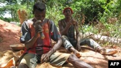 FILE - Young goldminers crush rocks to find gold dust on June 3, 2008 at the Kambele III site near the eastern Cameroonian town of Batouri.